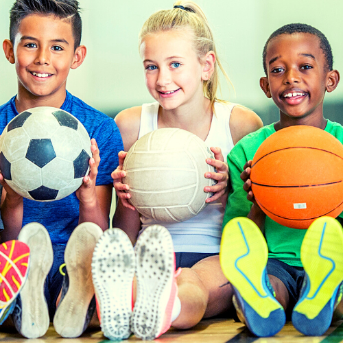 students with soccer, volleyball and basketball